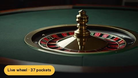 Spinning roulette wheel with the ball dropping toward the numbered pockets